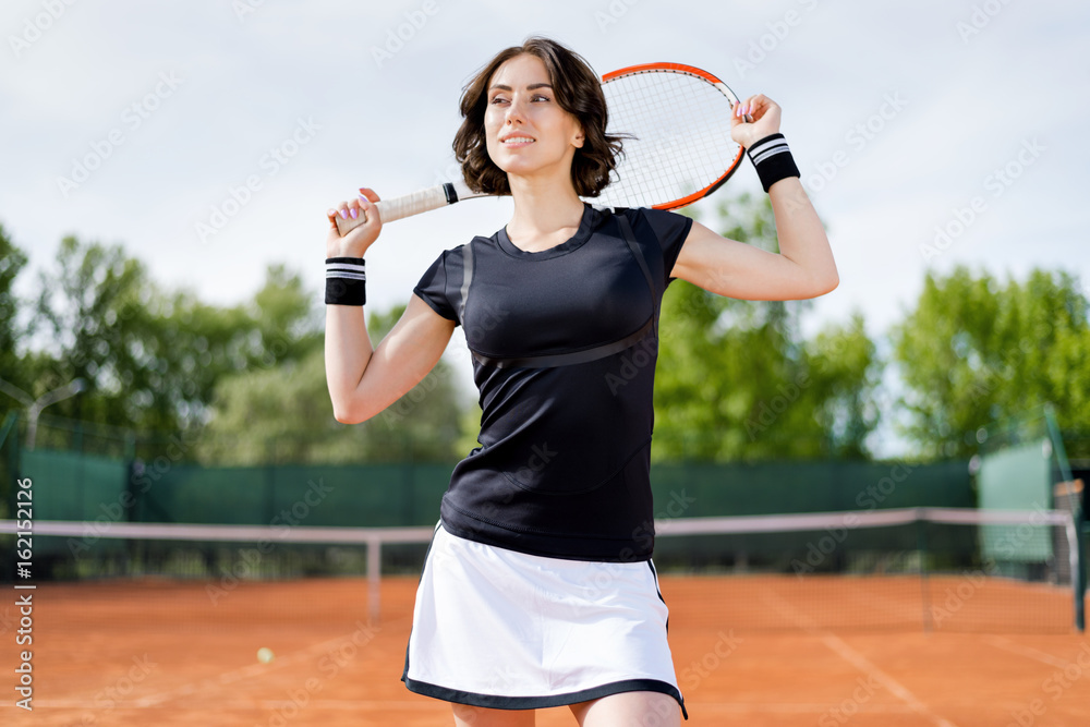 Beautiful young girl on the open tennis court