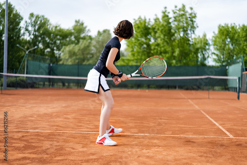 Beautiful young girl on the open tennis court © bondarchik