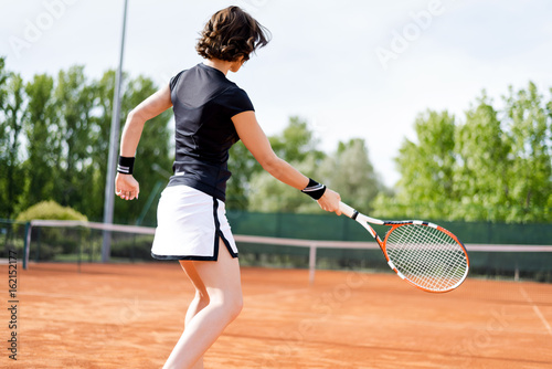 Beautiful young girl on the open tennis court © bondarchik