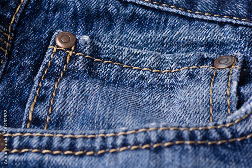 Jeans close-up. Clasps, pocket, seams. Interlacing the fabric with a close-up Jeans close-up. Clasps, pocket, seams. Interlacing the fabric with a close-up
