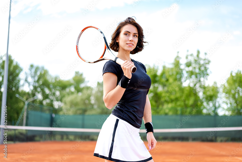 Beautiful young girl on the open tennis court