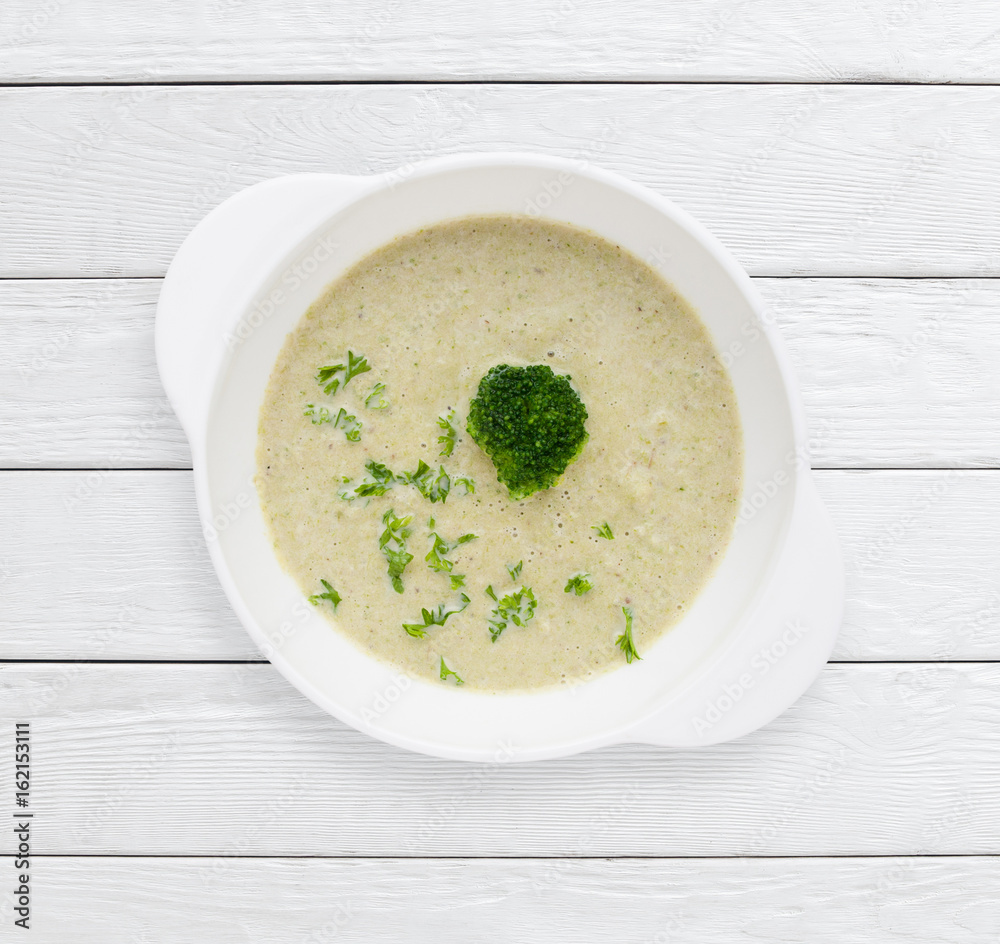 Delicious homemade cream of broccoli soup. Healthy food, delicacy, lunch dish concept. White wooden planks background. Delicious homemade cream of broccoli soup. Healthy food, delicacy, lunch dish concept. White wooden planks background.