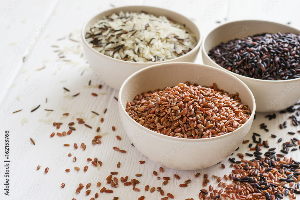 Selection of variety of gourmet rice in bowls. Selective focus, copy space Selection of variety of gourmet rice in bowls. Selective focus, copy space