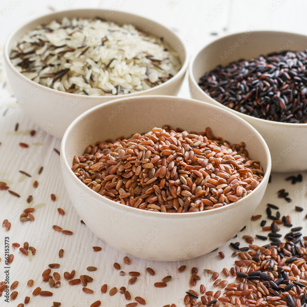 Selection of variety of gourmet rice in bowls. Selective focus Selection of variety of gourmet rice in bowls. Selective focus