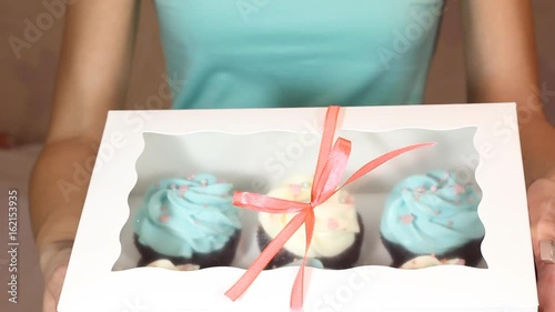 Baker puts cupcakes into the box, beautiful and delicious food, cooking and baking in the kitchen. HD