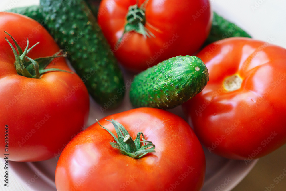 Fresh, ripe red tomatoes and pickled cucumbers. Fresh, ripe red tomatoes and pickled cucumbers.