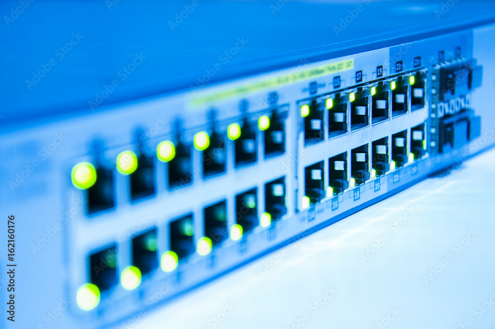 Network switch online green status in blue tone with depth of field