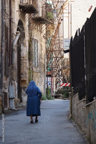 Nun walking in the street © elisabono