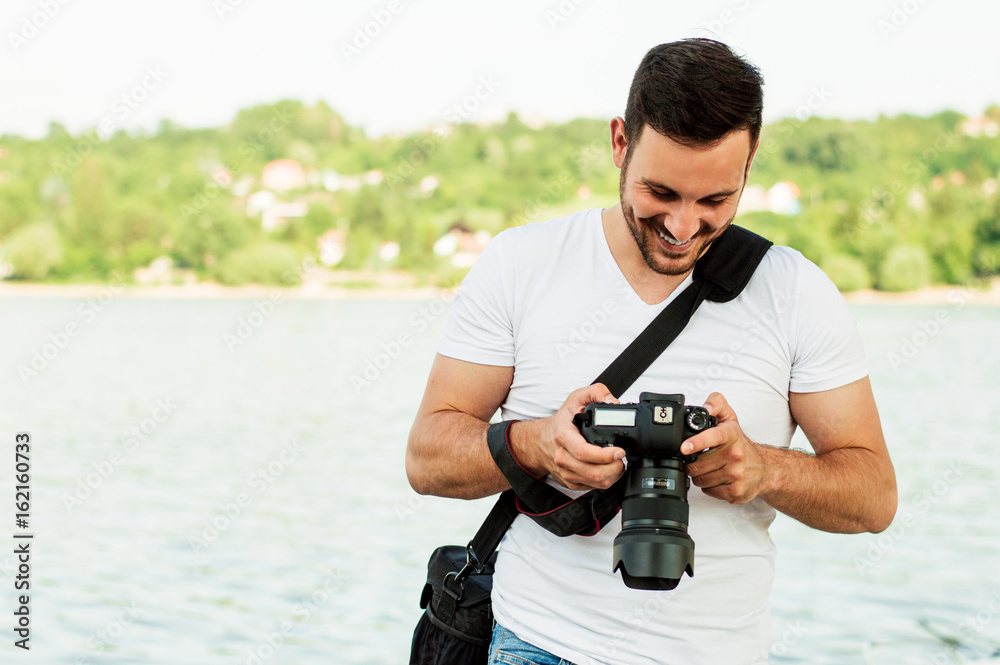Young man photographer takes pictures with dslr camera Young man photographer takes pictures with dslr camera