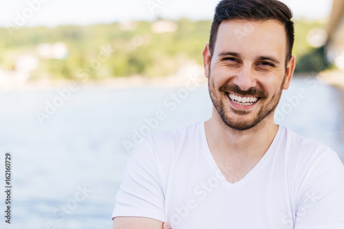 Close up of a man smiling outside