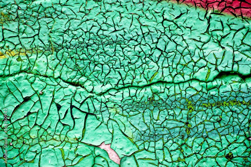 The old wall is painted with green paint, which from time to time has dried up and cracked. The old wall is painted with green paint, which from time to time has dried up and cracked.