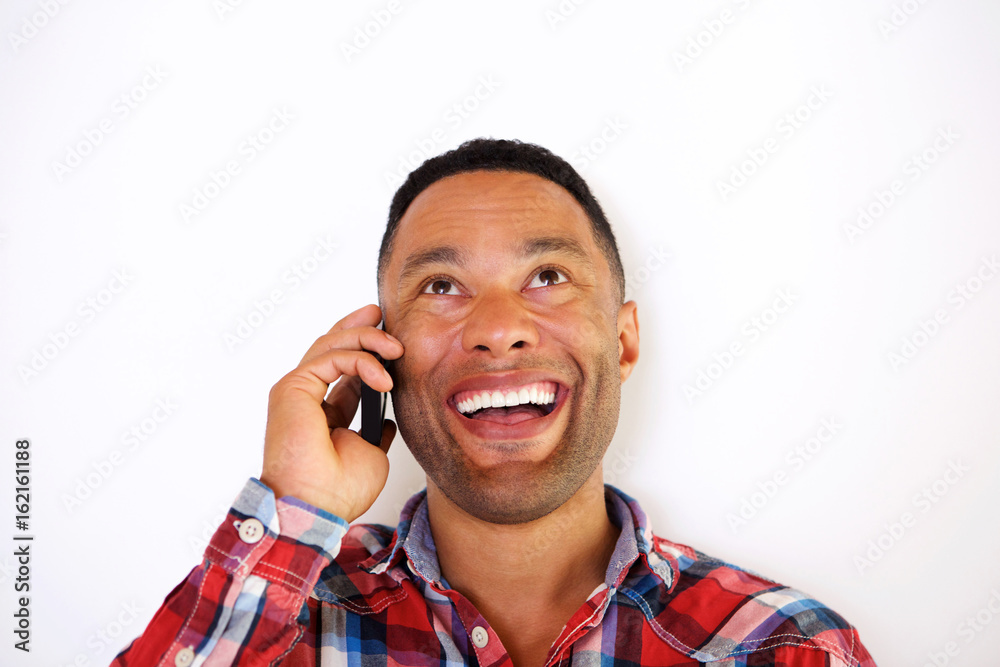 Close up smiling young african man talking on smart phone Close up smiling young african man talking on smart phone