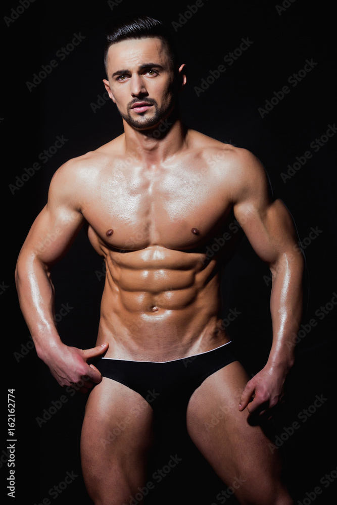 muscular man with muscle torso in studio, sport and training
