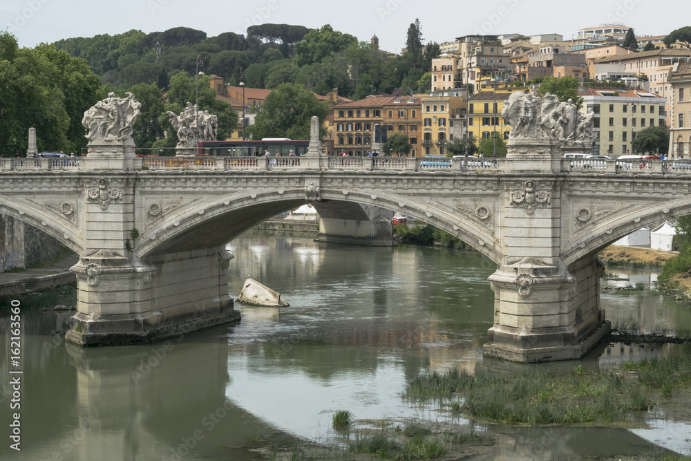 View on river Tiber and Vittorio Emanuele II bridge from Vatican Embankment in Rome, Italy, in June.
