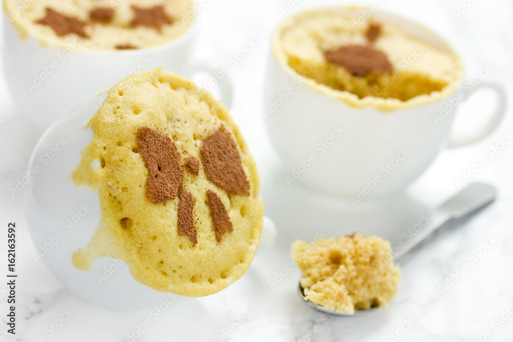 Microwave mug cake in white cups Microwave mug cake in white cups