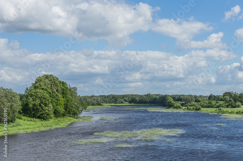 Beautiful landscape river forest with big clouds