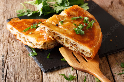 Delicious appetizer: Balkan burek with minced meat close-up. horizontal