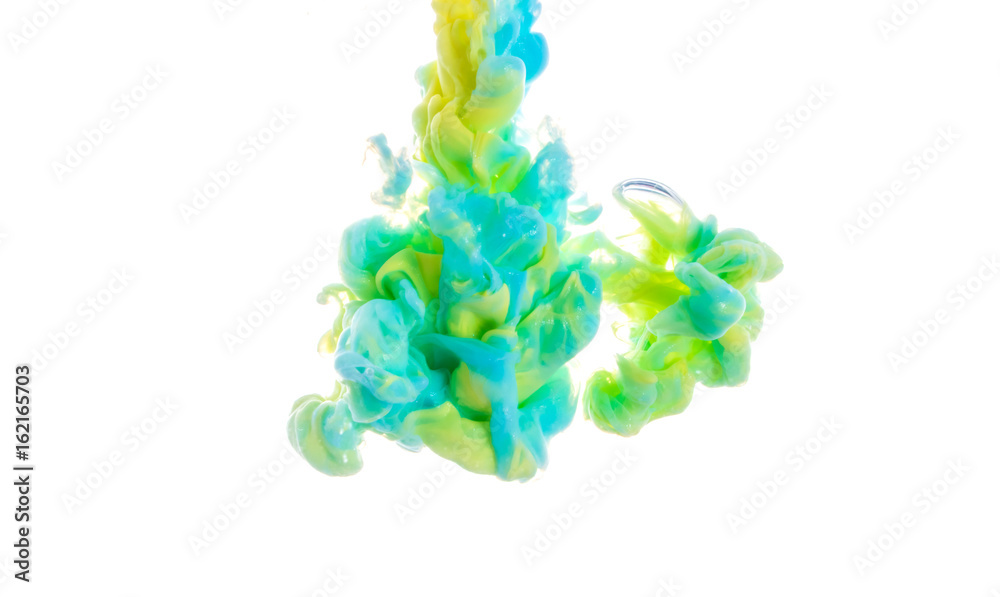 Yellow, blue, and green acrylic colors. Ink swirling in water. Color explosion