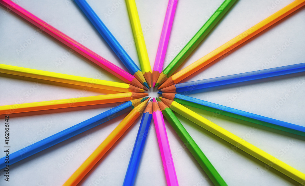Colored pencils lined on a white sheet of paper Colored pencils lined on a white sheet of paper