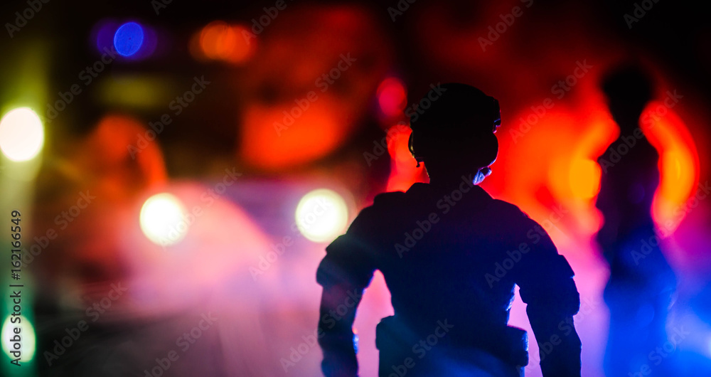 Anti-riot police give signal to be ready. Government power concept. Police in action. Smoke on a dark background with lights. Blue red flashing sirens. Anti-riot police give signal to be ready. Government power concept. Police in action. Smoke on a dark background with lights. Blue red flashing sirens.