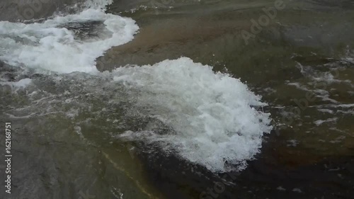 rapids river stream inlets on boulders. photo