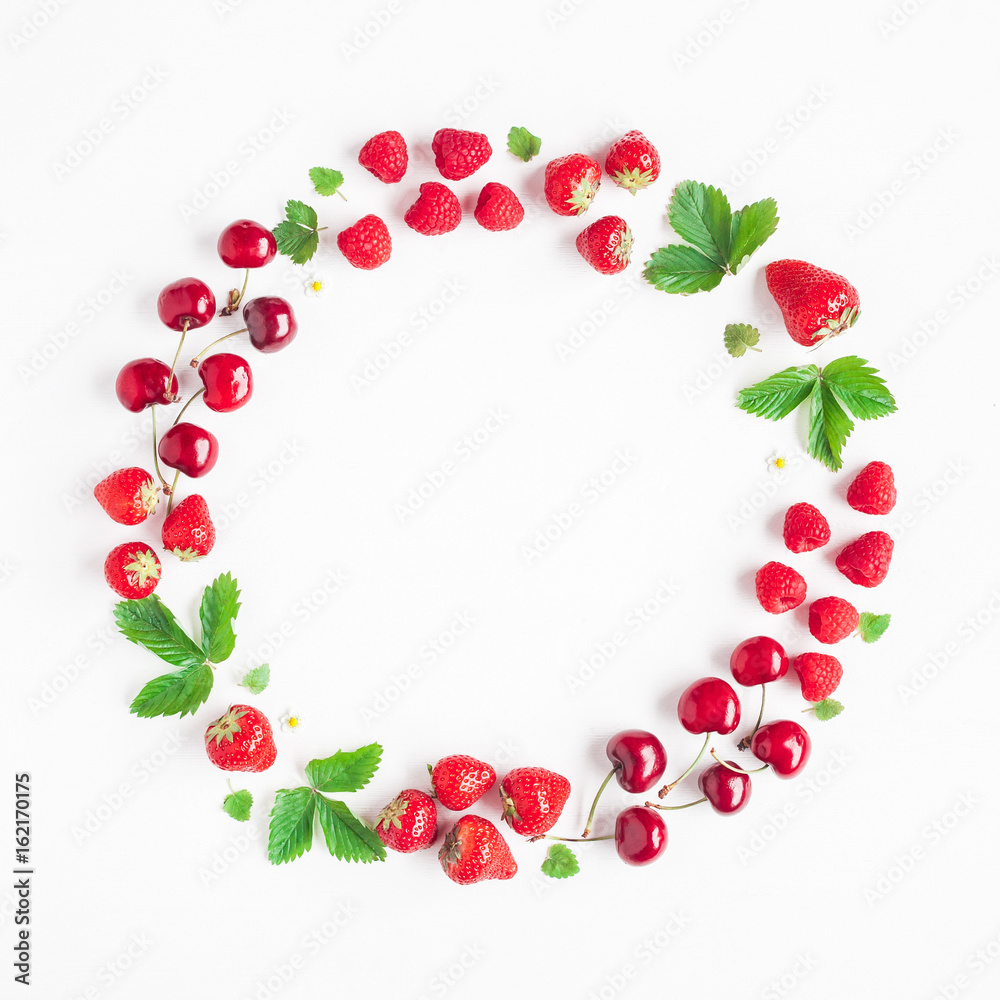 Fruits on white background. Creative frame made of fresh fruits. Strawberry, raspberry, blueberry and sweet cherry. Summer concept. Flat lay, top view, copy space Fruits on white background. Creative frame made of fresh fruits. Strawberry, raspberry, blueberry and sweet cherry. Summer concept. Flat lay, top view, copy space