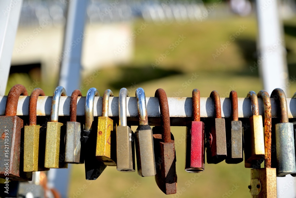Padlocks in love on the bridge on a sunny summer afternoon