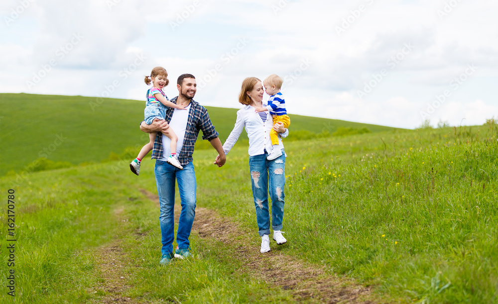 Happy family: mother, father, children son and  daughter on summer nature   
