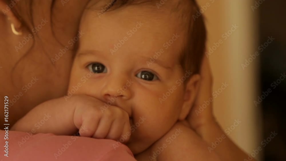 Mom holds a newborn baby in her arms