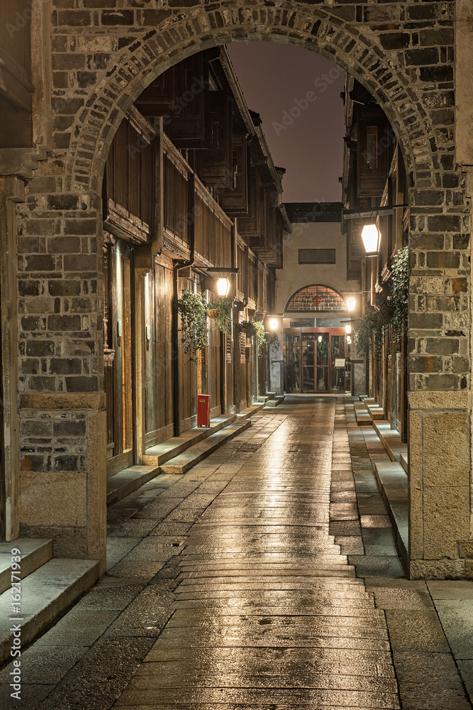 Fototapeta premium Narrow street in the old town of Wuzhen, China at night