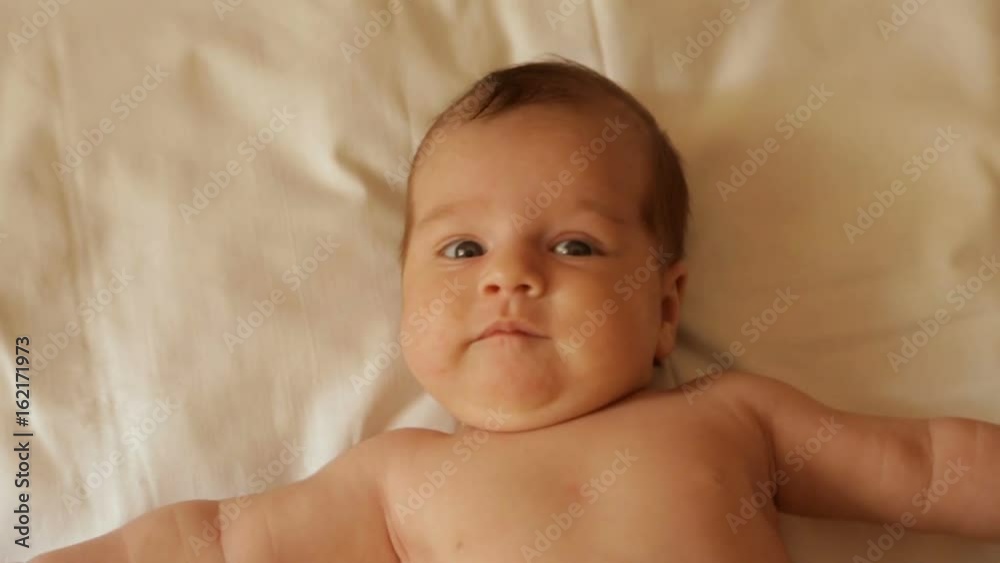 A newborn baby lies on its back A newborn baby lies on its back
