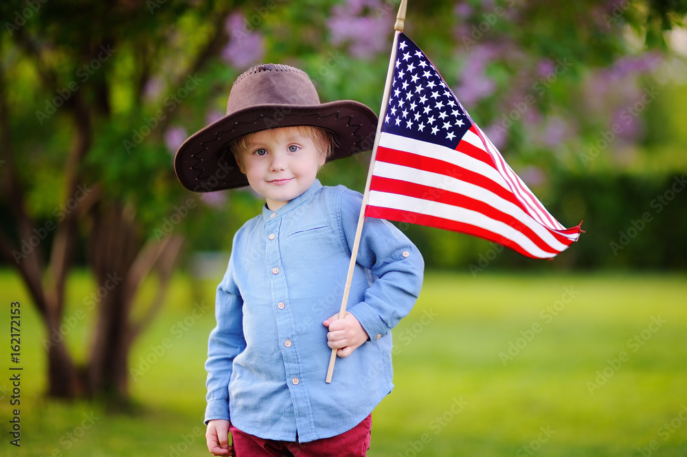 Cute toddler boy holding american flag in beautiful park Stock Photo ...