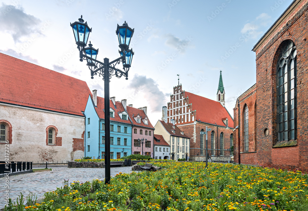 Floral square and medieval buildings and churches in old Riga city, Latvia
