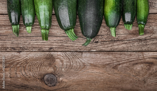 Fresh farmer organic zucchini on a wooden background