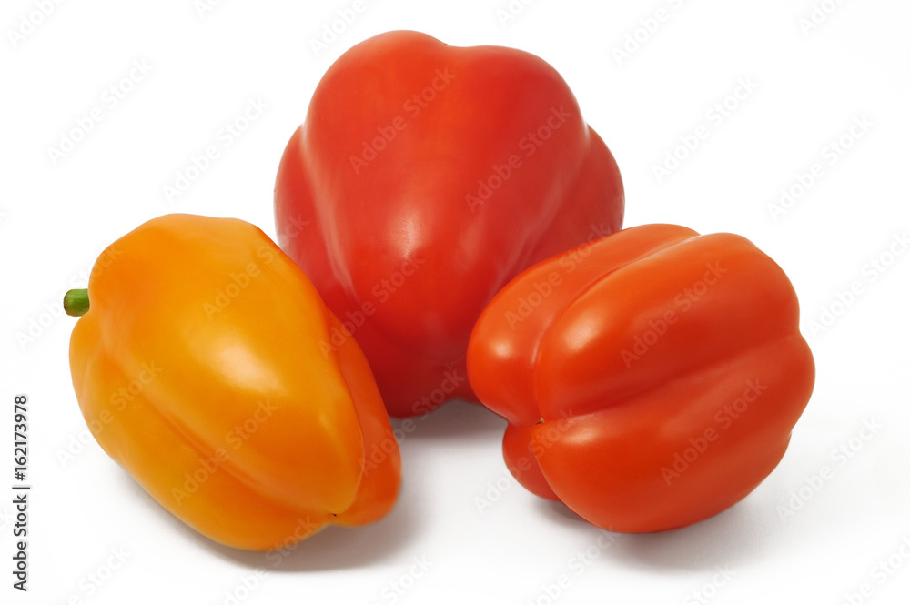 Red and orange bell pepers in horizontal position on white background Red and orange bell pepers in horizontal position on white background