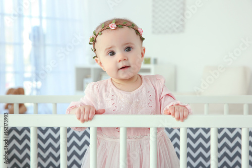 Cute little girl standing i...