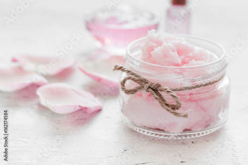 rose organic cosmetics with salt, cream and oil on white table background