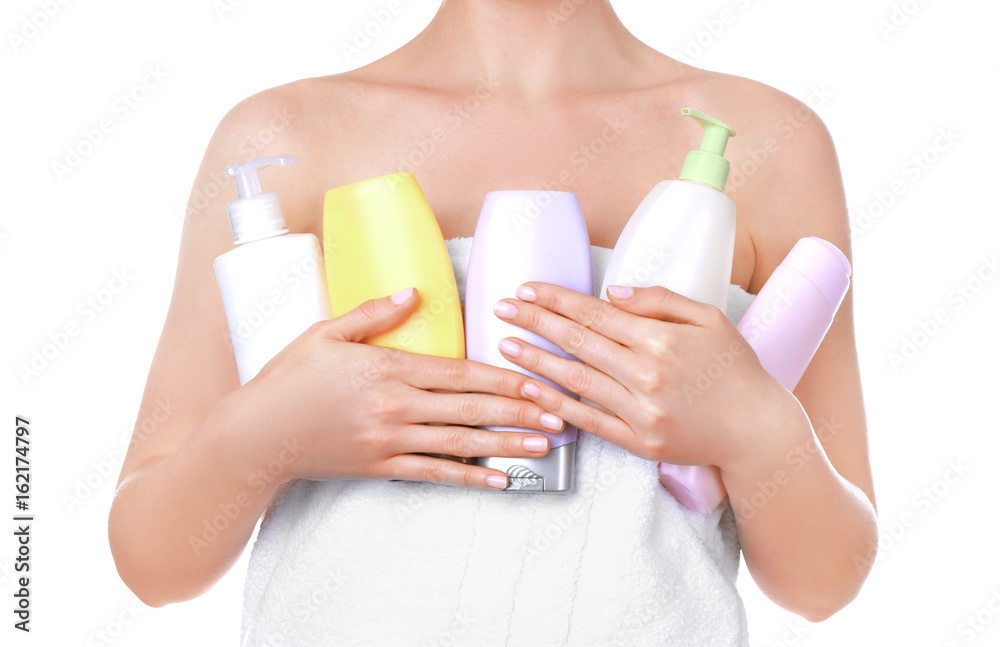 Fototapeta premium Young woman after shower with cosmetic products on white background, closeup