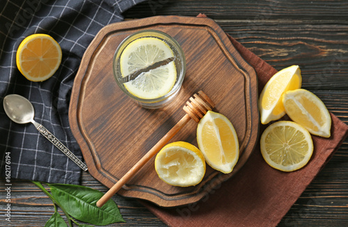 Composition with cold lemon water on wooden table