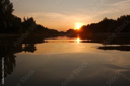 Sunset over a river © Gudellaphoto