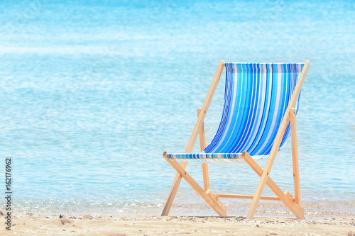 Comfortable beach chair at sea shore. Vacation concept © Africa Studio