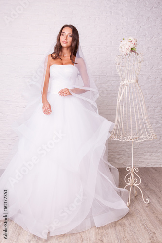 Beautiful woman in wedding dress pose in studio