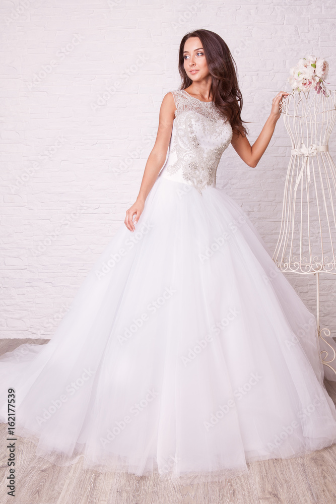 Beautiful woman in wedding dress pose in studio Beautiful woman in wedding dress pose in studio