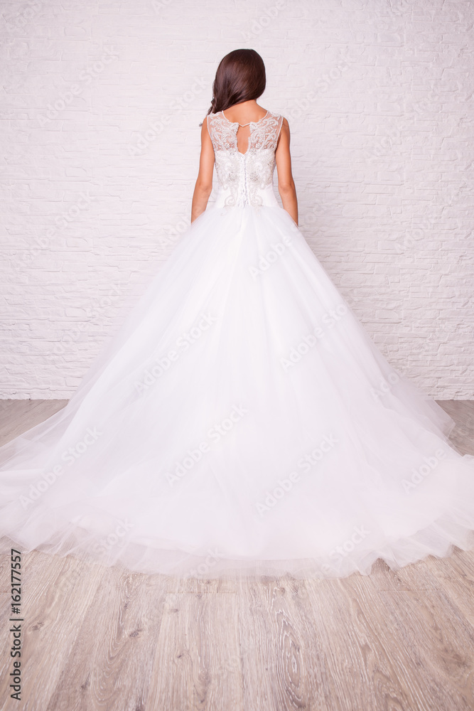 Beautiful white wedding dress with white laces from the back. Rhinestones, hand embroidery