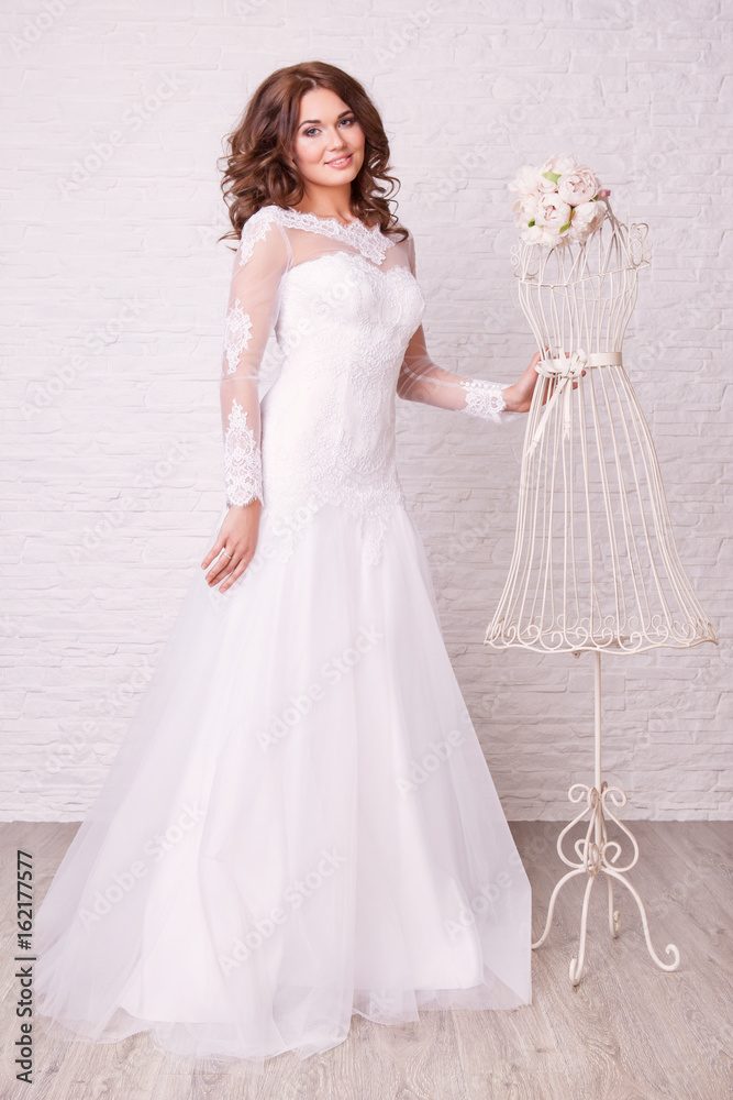 Beautiful woman in wedding dress pose in studio Beautiful woman in wedding dress pose in studio