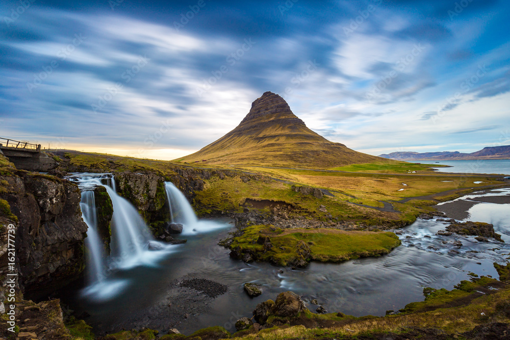 Kirkjufellsfoss waterfall with Kirkjufell mountain in the background at sunset, Iceland Kirkjufellsfoss waterfall with Kirkjufell mountain in the background at sunset, Iceland
