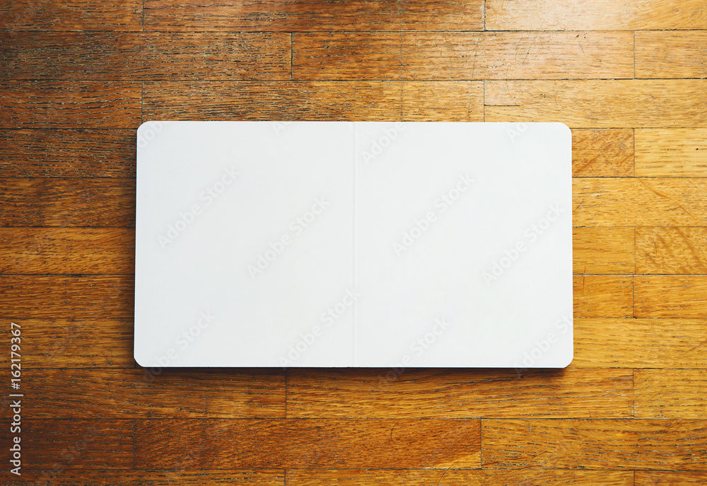 Open empty book with blank pages on textured woodend background. Open empty book with blank pages on textured woodend background.