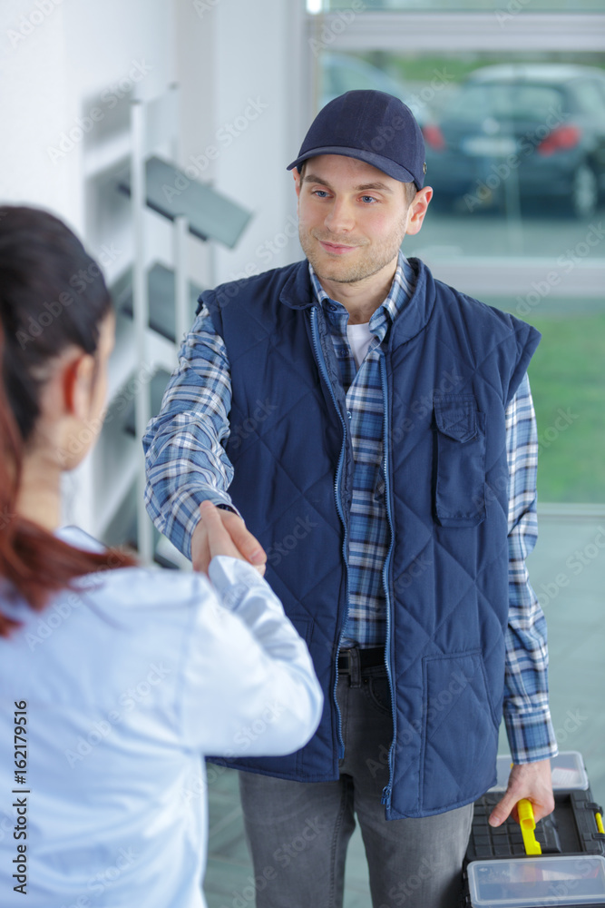 handyman with toolbox shaking clients hand handyman with toolbox shaking clients hand