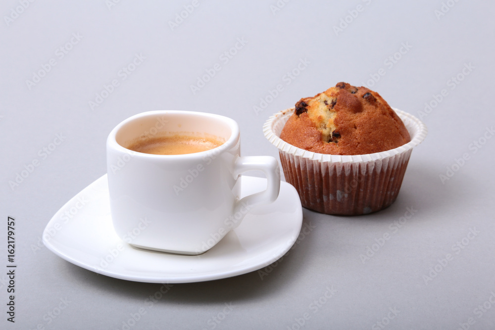 Classic espresso in white cup with homemade cake and chocolate on white background. Classic espresso in white cup with homemade cake and chocolate on white background.