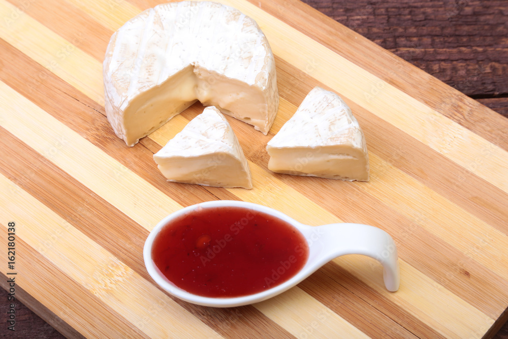 Cheese with white mold. Camembert or brie type with Cranberry sauce.. Healthy breakfast.